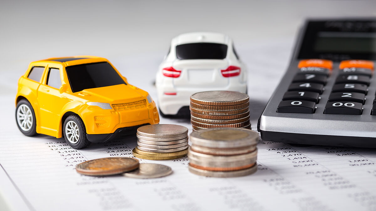 Financement Cars and coins with calculator on financial statement