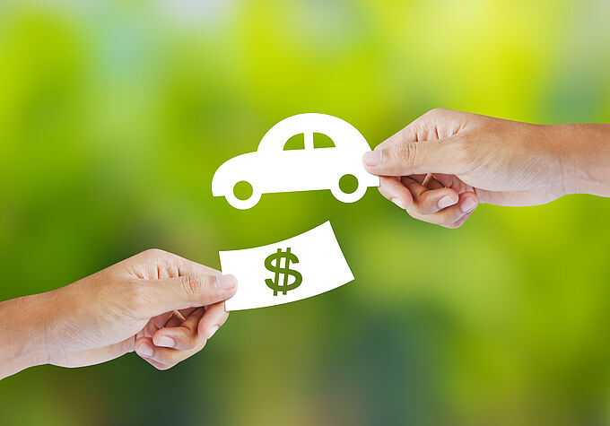 Hand with paper money and car shape. new car buy concept Hand with paper money and car shape. new car buy concept